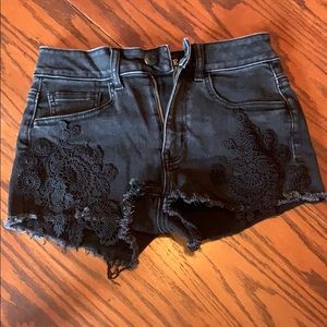 Black cut off denim shorts with crochet detail